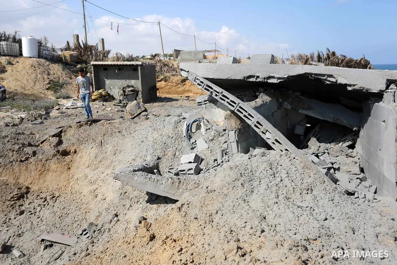 A Palestinian man inspects the site targeted by an Israeli air strike, in Khan younis in the southern Gaza strip, May 30, 2018. The Israeli Defense Forces said it launched more than 35 airstrikes targeting the militant g...