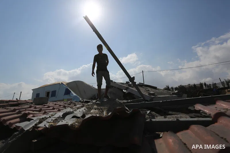 A Palestinian man inspects the site targeted by an Israeli air strike, in Khan younis in the southern Gaza strip, May 30, 2018. The Israeli Defense Forces said it launched more than 35 airstrikes targeting the militant g...