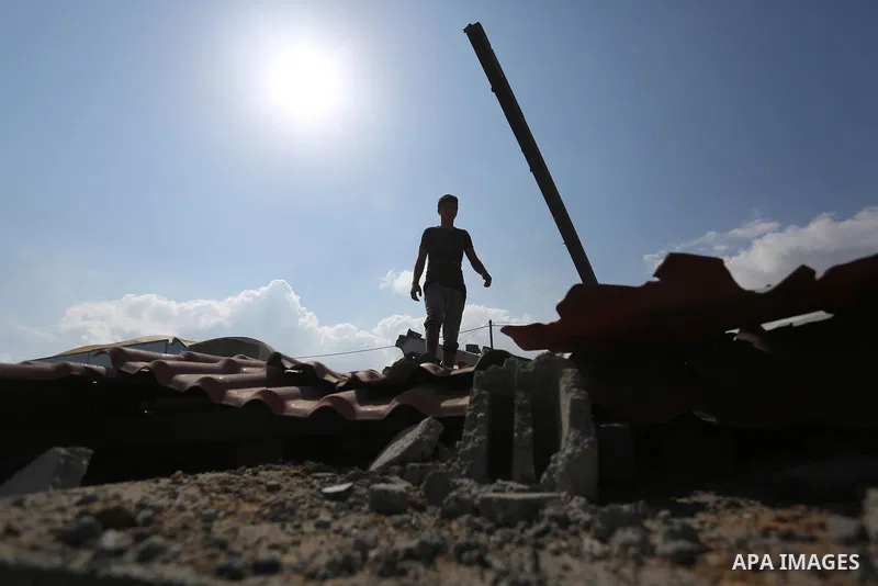 A Palestinian man inspects the site targeted by an Israeli air strike, in Khan younis in the southern Gaza strip, May 30, 2018. The Israeli Defense Forces said it launched more than 35 airstrikes targeting the militant g...