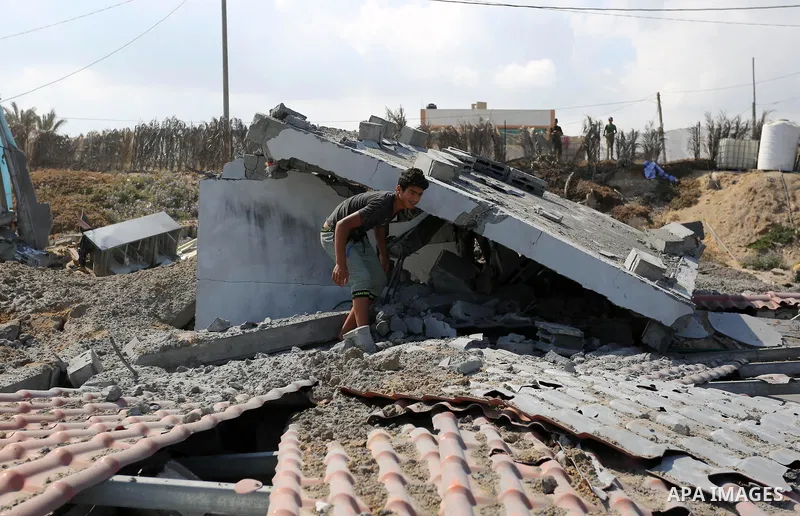 A Palestinian man inspects the site targeted by an Israeli air strike, in Khan younis in the southern Gaza strip, May 30, 2018. The Israeli Defense Forces said it launched more than 35 airstrikes targeting the militant g...