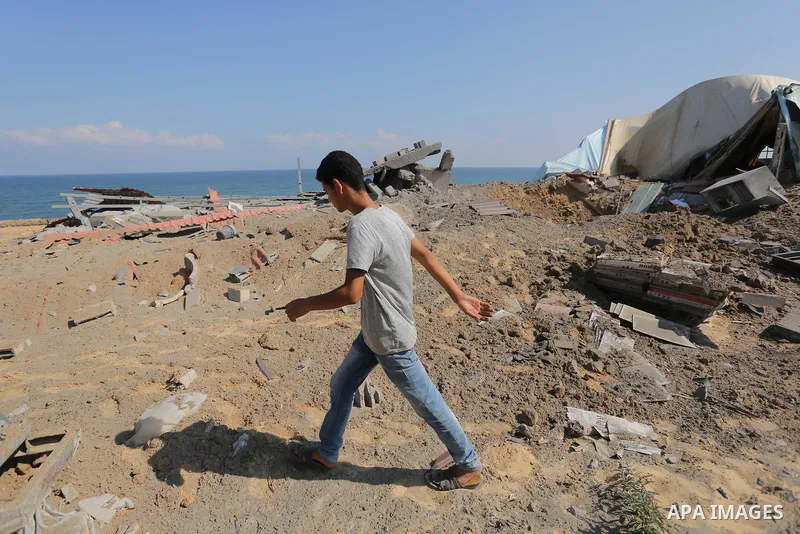 A Palestinian man inspects the site targeted by an Israeli air strike, in Khan younis in the southern Gaza strip, May 30, 2018. The Israeli Defense Forces said it launched more than 35 airstrikes targeting the militant g...