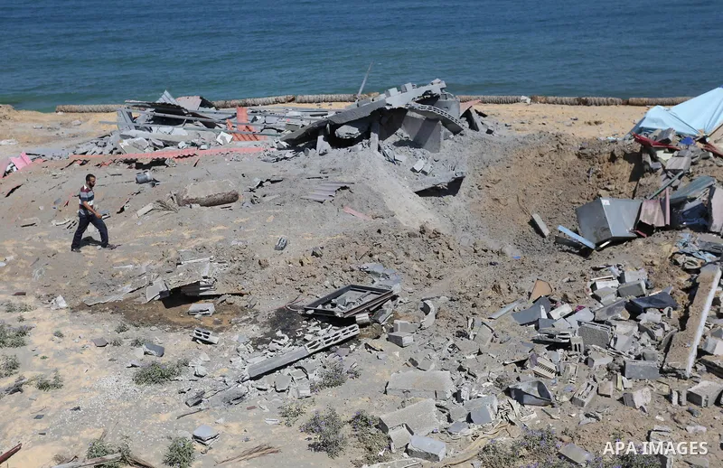 A Palestinian man inspects the site targeted by an Israeli air strike, in Khan younis in the southern Gaza strip, May 30, 2018. The Israeli Defense Forces said it launched more than 35 airstrikes targeting the militant g...