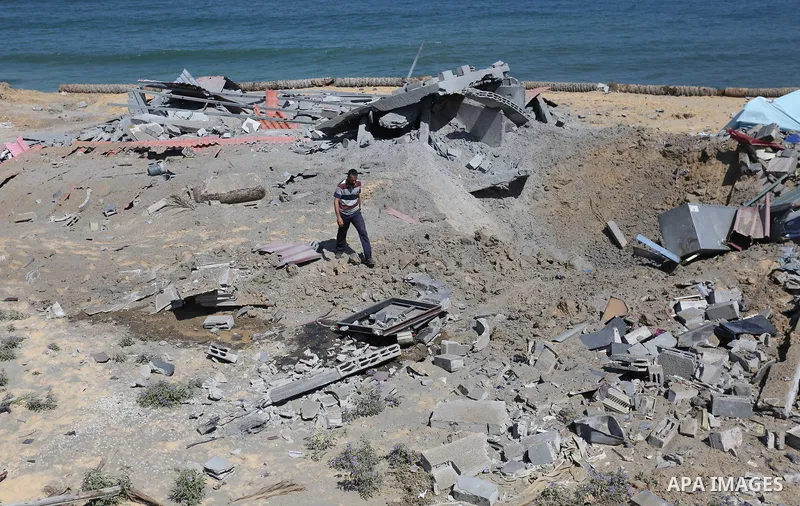 A Palestinian man inspects the site targeted by an Israeli air strike, in Khan younis in the southern Gaza strip, May 30, 2018. The Israeli Defense Forces said it launched more than 35 airstrikes targeting the militant g...