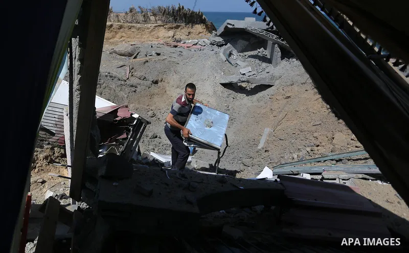 A Palestinian man inspects the site targeted by an Israeli air strike, in Khan younis in the southern Gaza strip, May 30, 2018. The Israeli Defense Forces said it launched more than 35 airstrikes targeting the militant g...