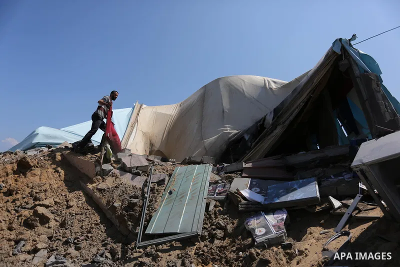 A Palestinian man inspects the site targeted by an Israeli air strike, in Khan younis in the southern Gaza strip, May 30, 2018. The Israeli Defense Forces said it launched more than 35 airstrikes targeting the militant g...