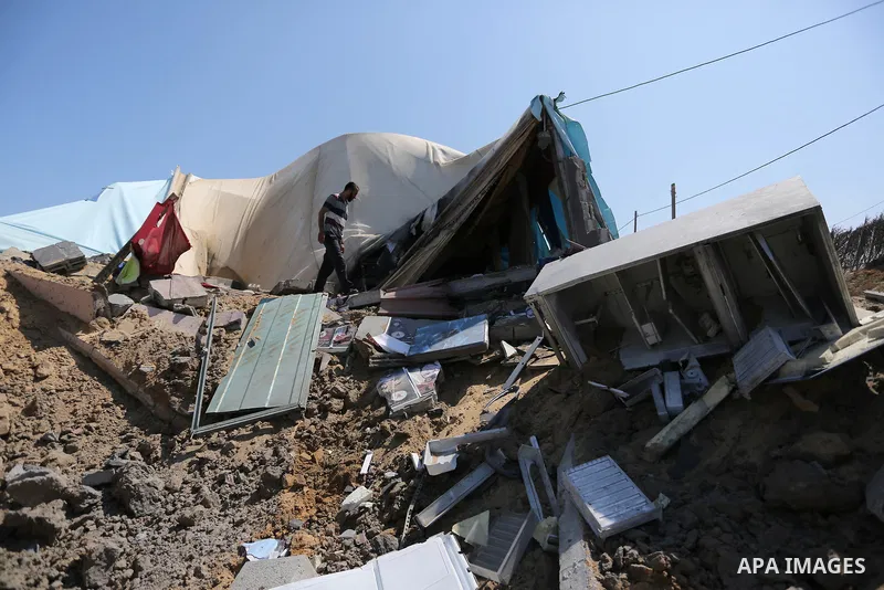 A Palestinian man inspects the site targeted by an Israeli air strike, in Khan younis in the southern Gaza strip, May 30, 2018. The Israeli Defense Forces said it launched more than 35 airstrikes targeting the militant g...