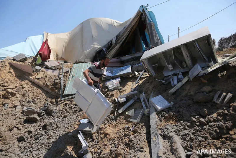A Palestinian man inspects the site targeted by an Israeli air strike, in Khan younis in the southern Gaza strip, May 30, 2018. The Israeli Defense Forces said it launched more than 35 airstrikes targeting the militant g...