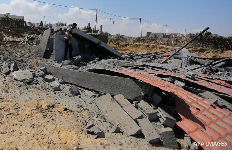 A Palestinian man inspects the site targeted by an Israeli air strike, in Khan younis in the southern Gaza strip, May 30, 2018. The Israeli Defense Forces said it launched more than 35 airstrikes targeting the militant g...