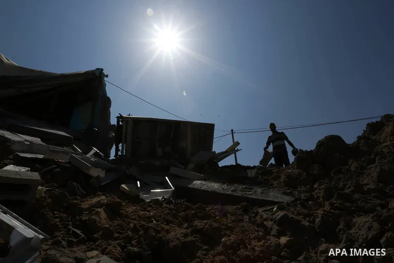 A Palestinian man inspects the site targeted by an Israeli air strike, in Khan younis in the southern Gaza strip, May 30, 2018. The Israeli Defense Forces said it launched more than 35 airstrikes targeting the militant g...