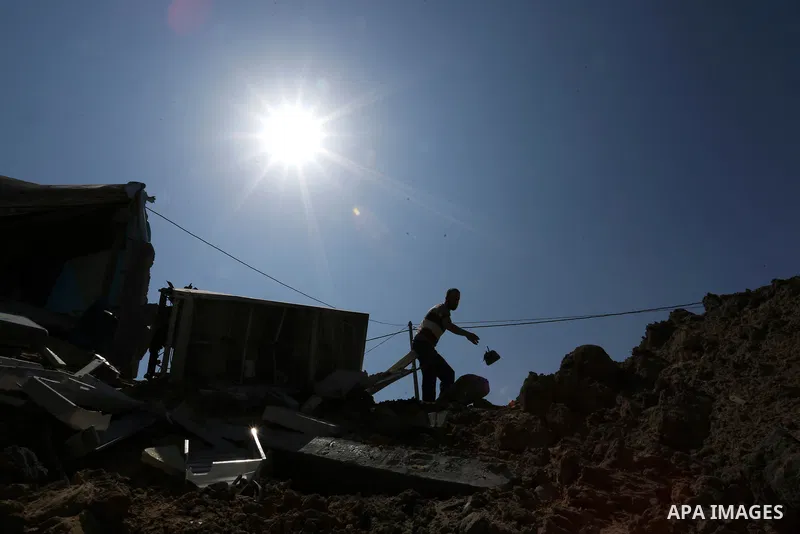 A Palestinian man inspects the site targeted by an Israeli air strike, in Khan younis in the southern Gaza strip, May 30, 2018. The Israeli Defense Forces said it launched more than 35 airstrikes targeting the militant g...