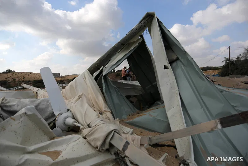 A Palestinian man inspects the site targeted by an Israeli air strike, in Khan younis in the southern Gaza strip, May 30, 2018. The Israeli Defense Forces said it launched more than 35 airstrikes targeting the militant g...