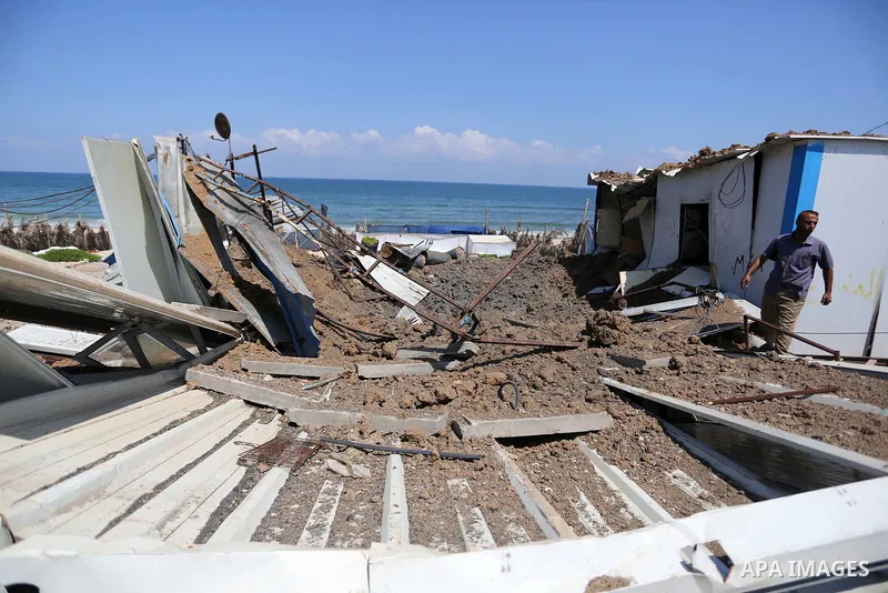 A Palestinian man inspects the site targeted by an Israeli air strike, in Khan younis in the southern Gaza strip, May 30, 2018. The Israeli Defense Forces said it launched more than 35 airstrikes targeting the militant g...