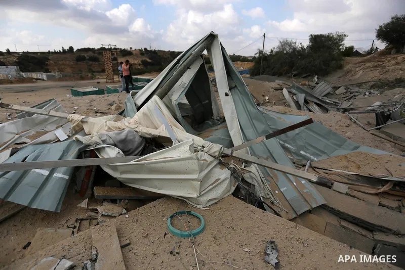 A Palestinian man inspects the site targeted by an Israeli air strike, in Khan younis in the southern Gaza strip, May 30, 2018. The Israeli Defense Forces said it launched more than 35 airstrikes targeting the militant g...