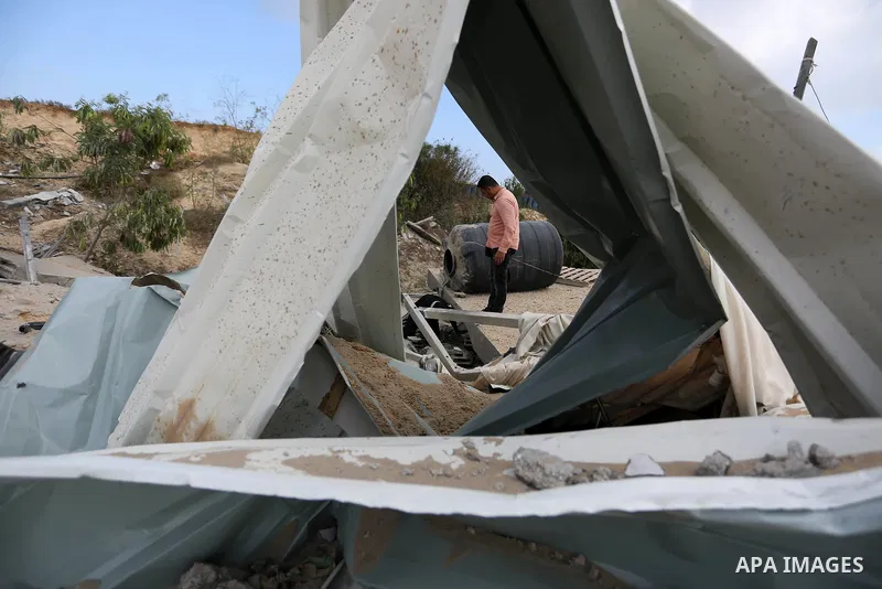 A Palestinian man inspects the site targeted by an Israeli air strike, in Khan younis in the southern Gaza strip, May 30, 2018. The Israeli Defense Forces said it launched more than 35 airstrikes targeting the militant g...