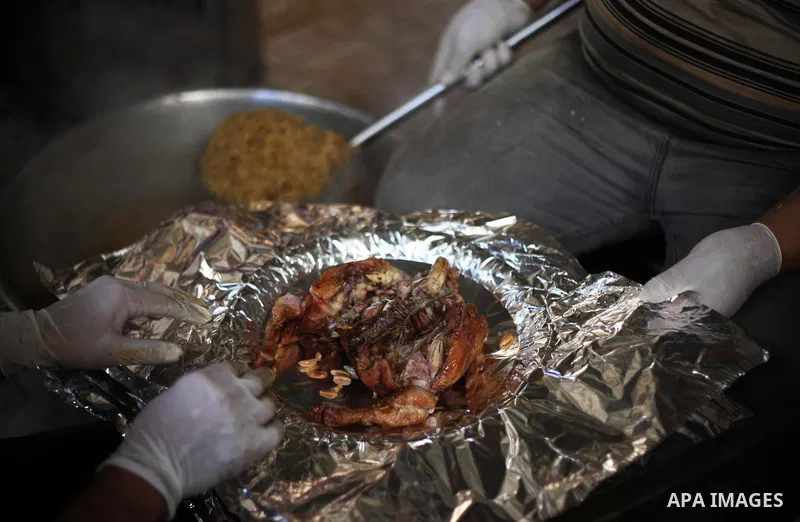 Palestinians prepare rice and chickens as they wait for customers several hours before Iftar, the breaking of the day long Ramadan fast in Gaza City, on May 30, 2018. Muslims around the world refrain from eating, drinkin...