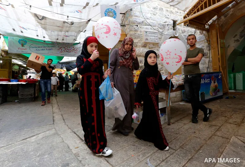 Palestinians shop at a market during the holy fasting month of Ramadan in the West Bank city of Hebron, May 30, 2018. Ramadan is sacred to Muslims because it is during that month that tradition says the Koran was reveale...