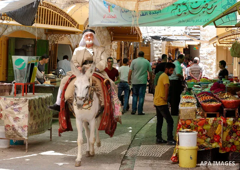 Palestinians shop at a market during the holy fasting month of Ramadan in the West Bank city of Hebron, May 30, 2018. Ramadan is sacred to Muslims because it is during that month that tradition says the Koran was reveale...