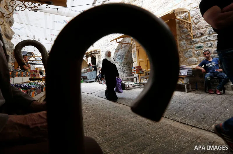 Palestinians shop at a market during the holy fasting month of Ramadan in the West Bank city of Hebron, May 30, 2018. Ramadan is sacred to Muslims because it is during that month that tradition says the Koran was reveale...