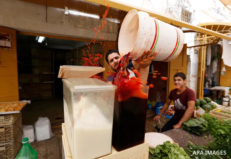 A Palestinian vendor sells Juices at a market during the holy fasting month of Ramadan in the West Bank city of Hebron, May 30, 2018. Ramadan is sacred to Muslims because it is during that month that tradition says the K...
