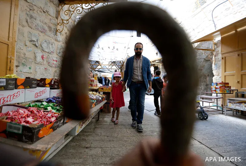 Palestinians shop at a market during the holy fasting month of Ramadan in the West Bank city of Hebron, May 30, 2018. Ramadan is sacred to Muslims because it is during that month that tradition says the Koran was reveale...