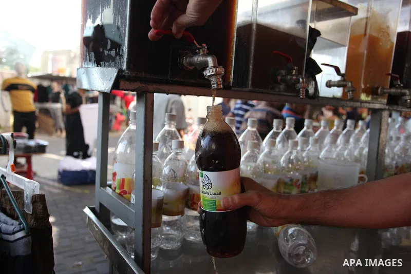 A Palestinian vendor sells carob Juice at a market during the holy fasting month of Ramadan in Gaza city of June 1, 2018. Ramadan is sacred to Muslims because it is during that month that tradition says the Koran was rev...