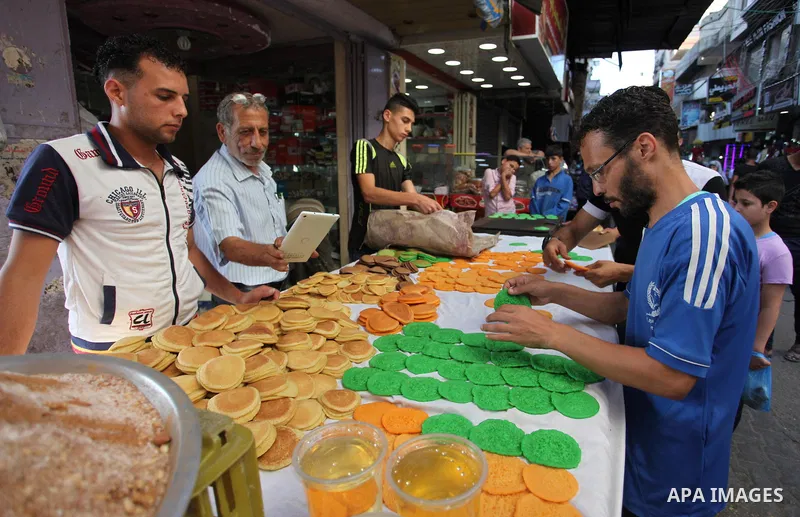 A Palestinian vendor prepares "Qatayef", traditional pancakes that are popular at a market during the holy month of Ramadan in Gaza city of June 1, 2018. Ramadan is sacred to Muslims because it is during that month that...