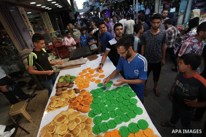 A Palestinian vendor prepares "Qatayef", traditional pancakes that are popular at a market during the holy month of Ramadan in Gaza city of June 1, 2018. Ramadan is sacred to Muslims because it is during that month that...