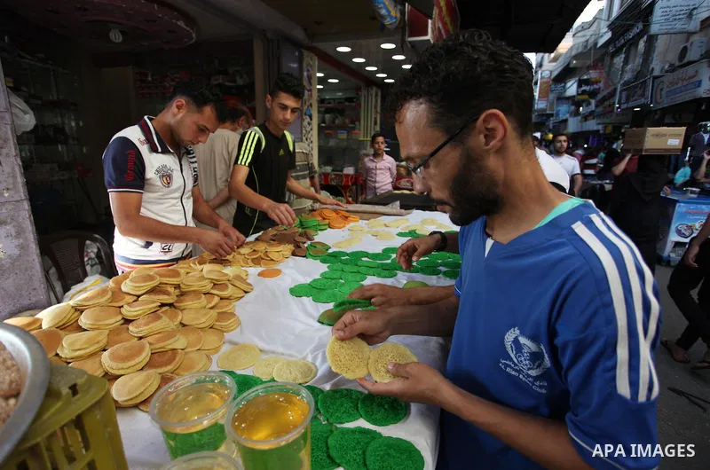 A Palestinian vendor prepares "Qatayef", traditional pancakes that are popular at a market during the holy month of Ramadan in Gaza city of June 1, 2018. Ramadan is sacred to Muslims because it is during that month that...