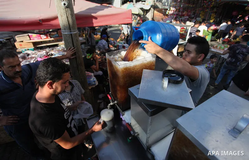 A Palestinian vendor sells carob Juice at a market during the holy fasting month of Ramadan in Gaza city of June 1, 2018. Ramadan is sacred to Muslims because it is during that month that tradition says the Koran was rev...