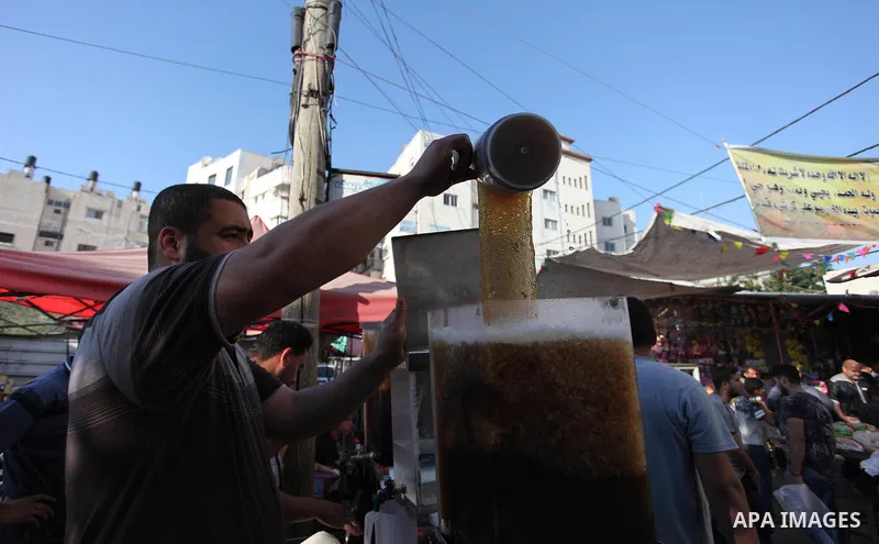 A Palestinian vendor sells carob Juice at a market during the holy fasting month of Ramadan in Gaza city of June 1, 2018. Ramadan is sacred to Muslims because it is during that month that tradition says the Koran was rev...