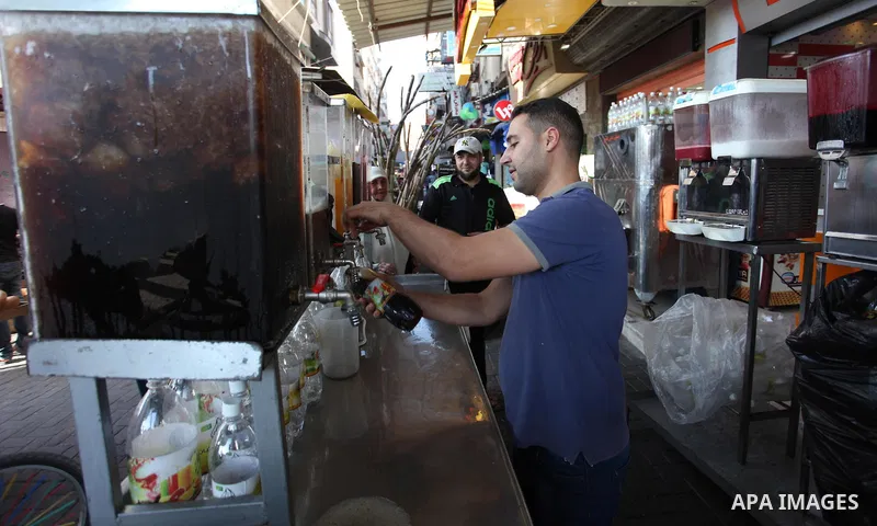 A Palestinian vendor sells carob Juice at a market during the holy fasting month of Ramadan in Gaza city of June 1, 2018. Ramadan is sacred to Muslims because it is during that month that tradition says the Koran was rev...