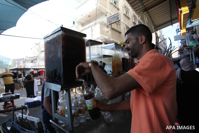 A Palestinian vendor sells carob Juice at a market during the holy fasting month of Ramadan in Gaza city of June 1, 2018. Ramadan is sacred to Muslims because it is during that month that tradition says the Koran was rev...