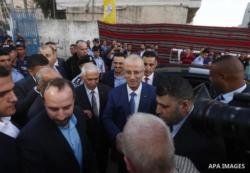 Palestinian Prime Minister, Rami Hamdallah, attends a charity breakfast to the families of martyrs and prisoners organized by the Fatah movement, during the holy month of Ramadan in the West Bank city of Hebron on June 1...