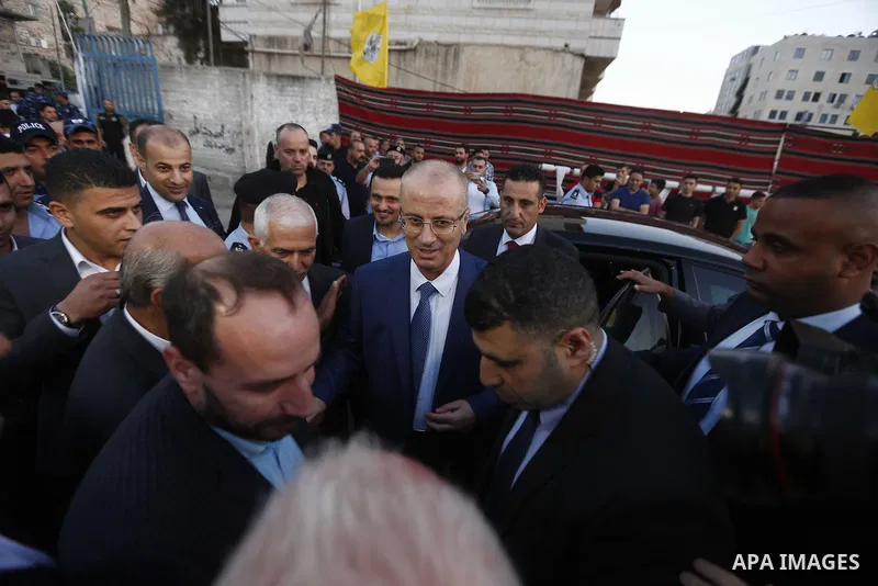 Palestinian Prime Minister, Rami Hamdallah, attends a charity breakfast to the families of martyrs and prisoners organized by the Fatah movement, during the holy month of Ramadan in the West Bank city of Hebron on June 1...