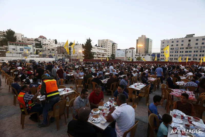 Palestinian Prime Minister, Rami Hamdallah, attends a charity breakfast to the families of martyrs and prisoners organized by the Fatah movement, during the holy month of Ramadan in the West Bank city of Hebron on June 1...