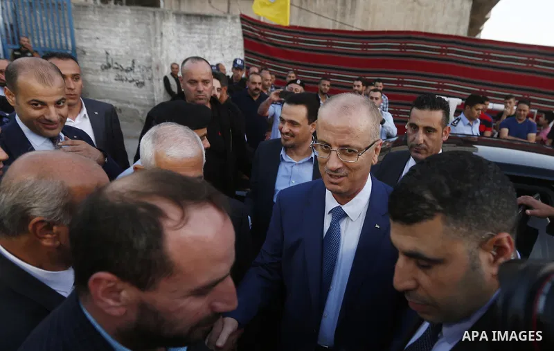 Palestinian Prime Minister, Rami Hamdallah, attends a charity breakfast to the families of martyrs and prisoners organized by the Fatah movement, during the holy month of Ramadan in the West Bank city of Hebron on June 1...