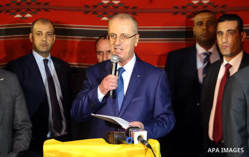 Palestinian Prime Minister, Rami Hamdallah, attends a charity breakfast to the families of martyrs and prisoners organized by the Fatah movement, during the holy month of Ramadan in the West Bank city of Hebron on June 1...