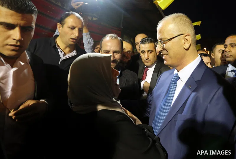 Palestinian Prime Minister, Rami Hamdallah, attends a charity breakfast to the families of martyrs and prisoners organized by the Fatah movement, during the holy month of Ramadan in the West Bank city of Hebron on June 1...