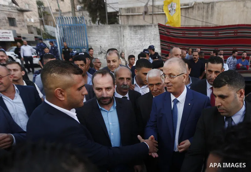 Palestinian Prime Minister, Rami Hamdallah, attends a charity breakfast to the families of martyrs and prisoners organized by the Fatah movement, during the holy month of Ramadan in the West Bank city of Hebron on June 1...