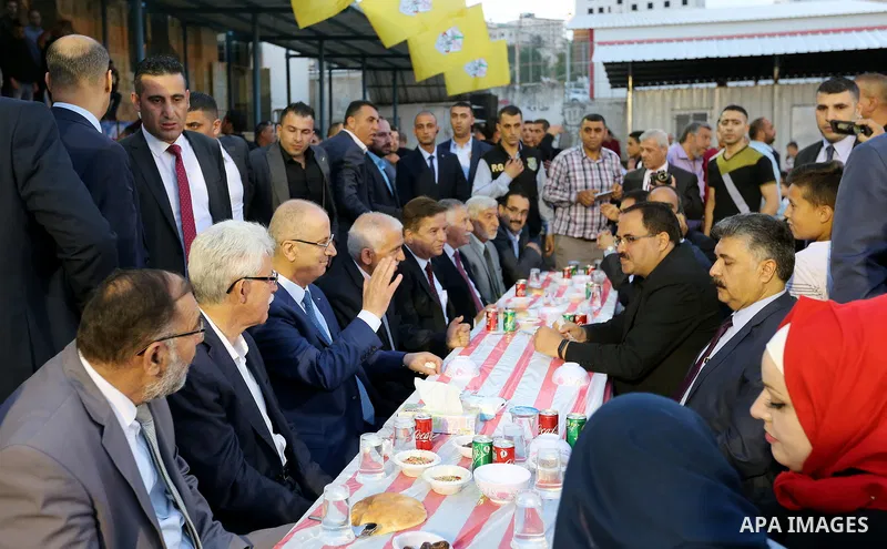 Palestinian Prime Minister, Rami Hamdallah, attends a charity breakfast to the families of martyrs and prisoners organized by the Fatah movement, during the holy month of Ramadan in the West Bank city of Hebron on June 1...