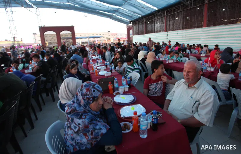 Palestinian families of martyrs and prisoners attends a breakfast during the holy fasting month of Ramadan in Gaza city on June 1, 2018. Ramadan is sacred to Muslims because it is during that month that tradition says th...