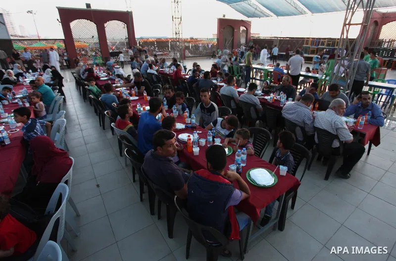 Palestinian families of martyrs and prisoners attends a breakfast during the holy fasting month of Ramadan in Gaza city on June 1, 2018. Ramadan is sacred to Muslims because it is during that month that tradition says th...