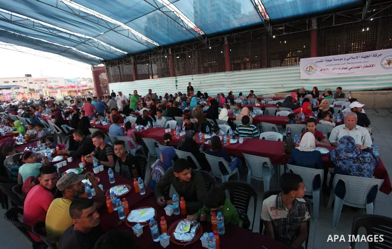 Palestinian families of martyrs and prisoners attends a breakfast during the holy fasting month of Ramadan in Gaza city on June 1, 2018. Ramadan is sacred to Muslims because it is during that month that tradition says th...