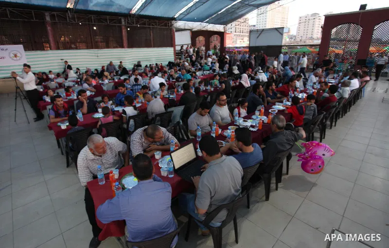 Palestinian families of martyrs and prisoners attends a breakfast during the holy fasting month of Ramadan in Gaza city on June 1, 2018. Ramadan is sacred to Muslims because it is during that month that tradition says th...