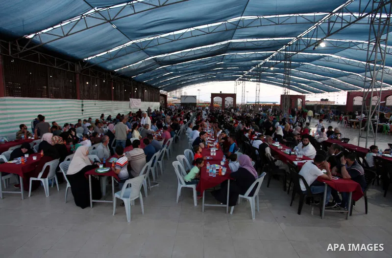 Palestinian families of martyrs and prisoners attends a breakfast during the holy fasting month of Ramadan in Gaza city on June 1, 2018. Ramadan is sacred to Muslims because it is during that month that tradition says th...