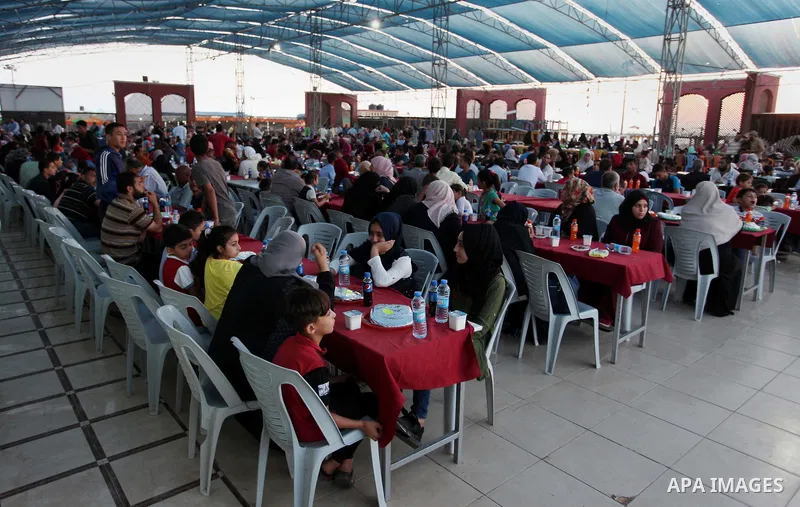 Palestinian families of martyrs and prisoners attends a breakfast during the holy fasting month of Ramadan in Gaza city on June 1, 2018. Ramadan is sacred to Muslims because it is during that month that tradition says th...