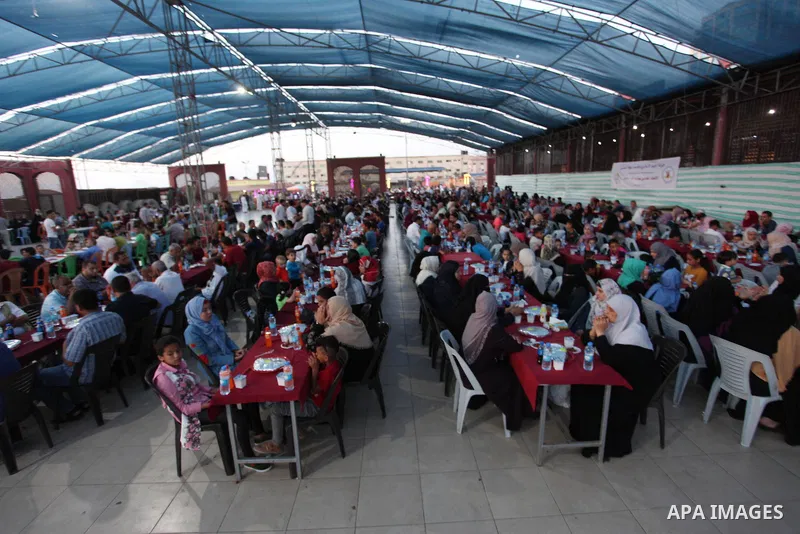 Palestinian families of martyrs and prisoners attends a breakfast during the holy fasting month of Ramadan in Gaza city on June 1, 2018. Ramadan is sacred to Muslims because it is during that month that tradition says th...