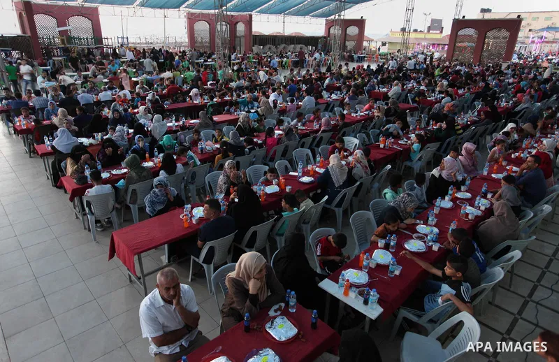 Palestinian families of martyrs and prisoners attends a breakfast during the holy fasting month of Ramadan in Gaza city on June 1, 2018. Ramadan is sacred to Muslims because it is during that month that tradition says th...