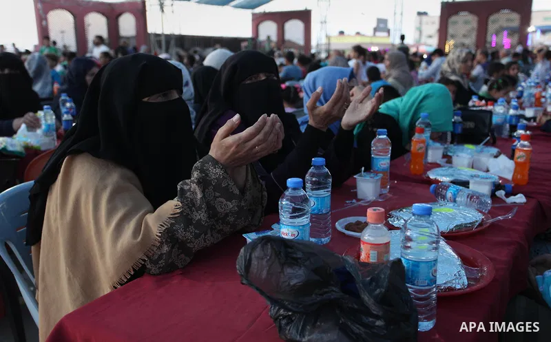 Palestinian families of martyrs and prisoners attends a breakfast during the holy fasting month of Ramadan in Gaza city on June 1, 2018. Ramadan is sacred to Muslims because it is during that month that tradition says th...