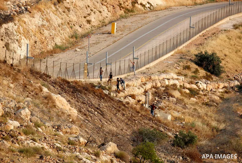 Palestinians try to make their way to attend the third Friday prayer of the holy fasting month of Ramadan in Jerusalem's Al-Aqsa mosque, after Israeli police prevented them from crossing to pray, in the West Bank city of...